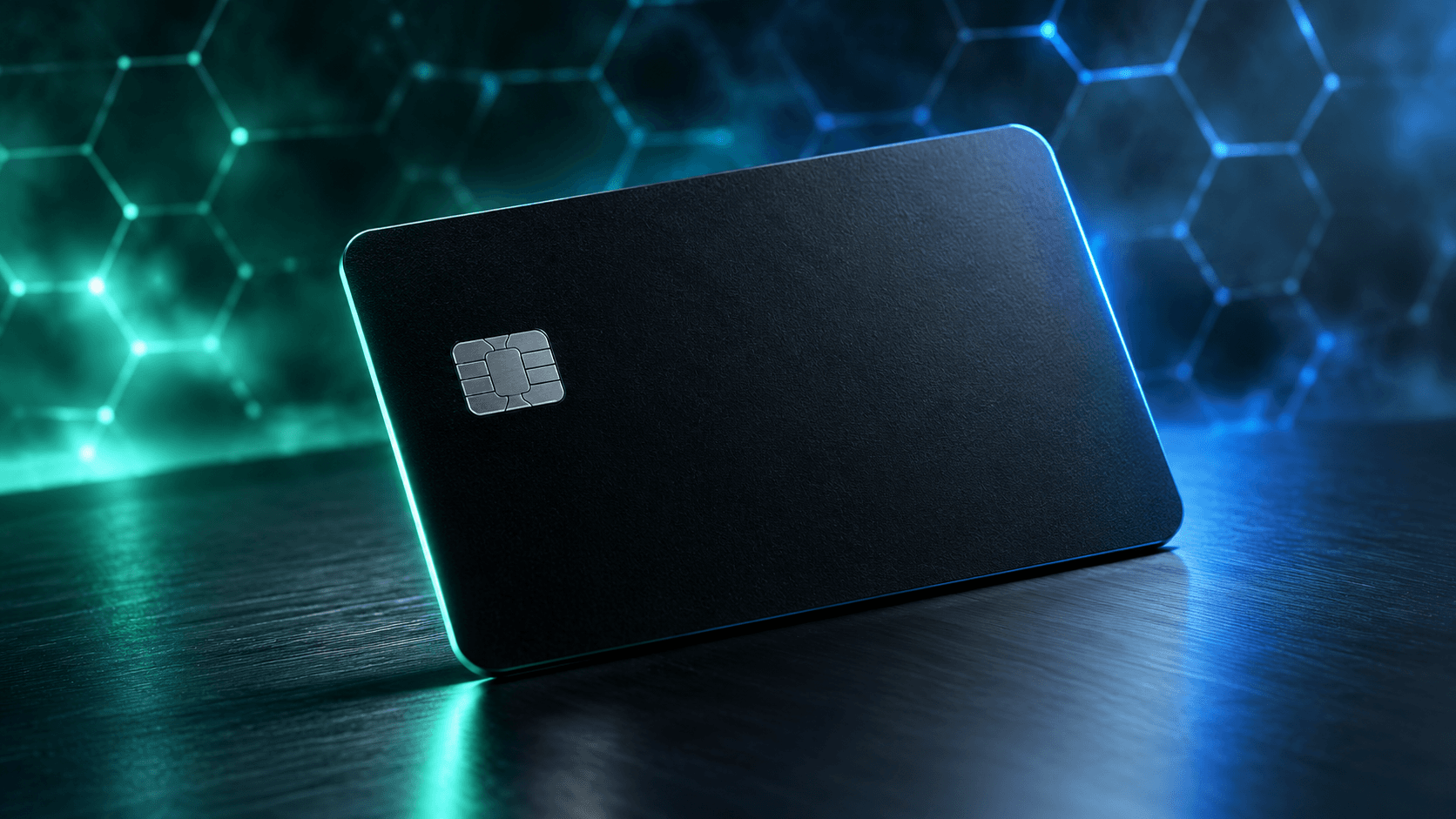 A matte black payment card resting at an angle on dark brushed metal, edge lit in mint and blue with a faint hexagonal network glowing behind it